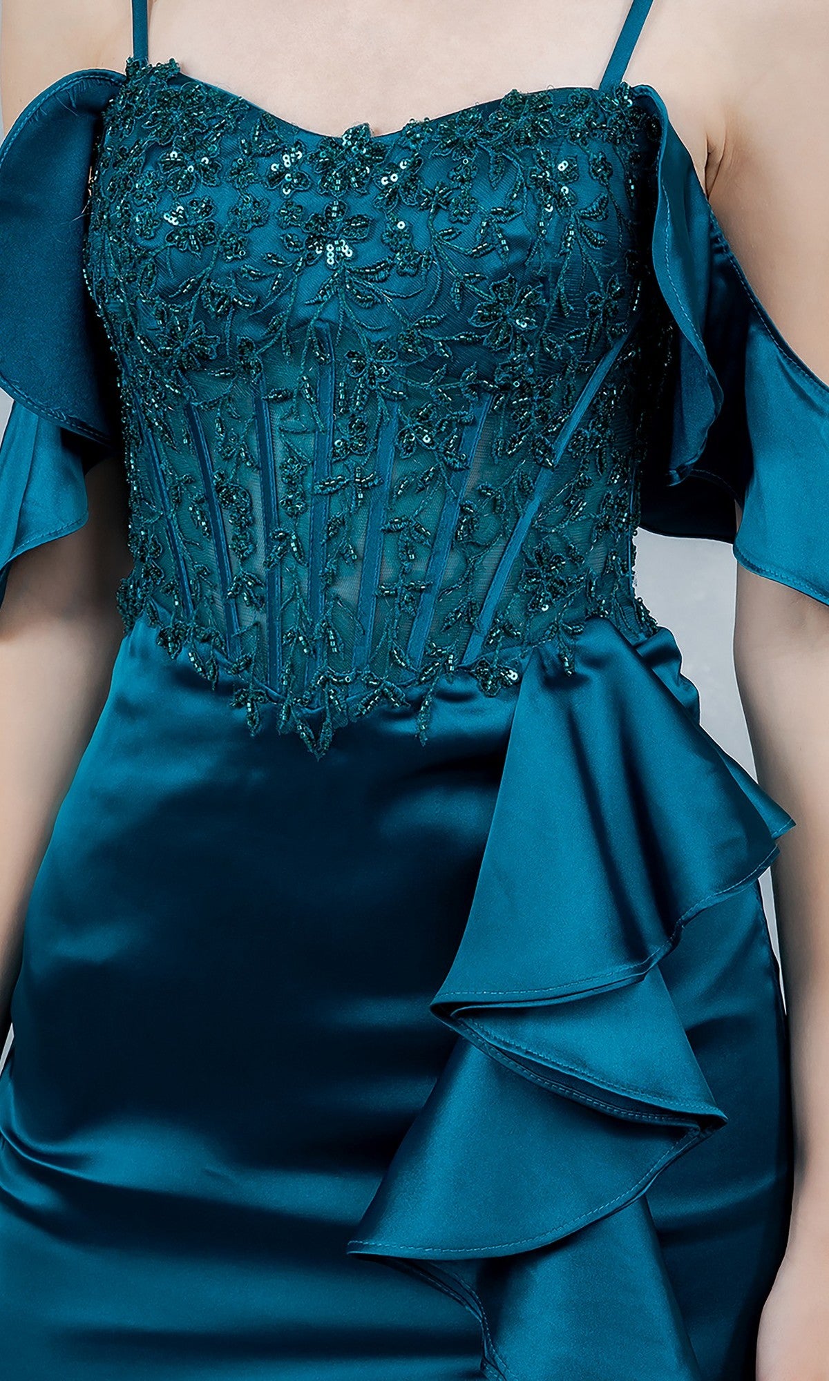 Close-up of the Cinderella Couture 8461J long prom dress in teal satin, featuring floral beaded embroidery on the bodice, off-the-shoulder sleeves, and a ruffled waist detail.